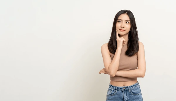 Young woman thoughtfully considering if she is a good candidate for Restylane Defyne treatment for facial rejuvenation